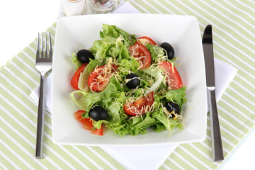 Light salad on plate on napkin