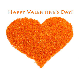 Heart of orange crystals of sea salt on grey background