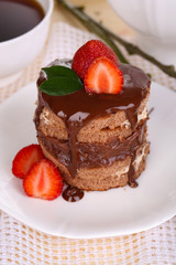 Chocolate cake with strawberry on table close-up