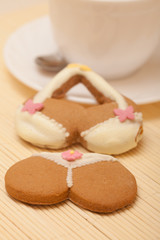 White cup bikini underwear gingerbread cake cookie on bamboo mat