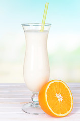 Milk shake on table on light blue background
