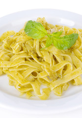 Delicious pasta with pesto on plate close-up