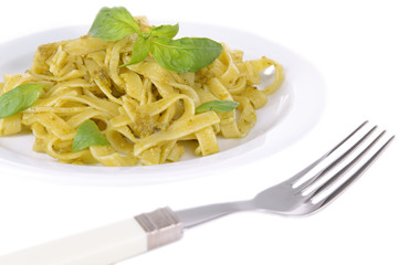 Delicious pasta with pesto on plate close-up