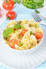 Delicious pasta with tomatoes on plate on table close-up