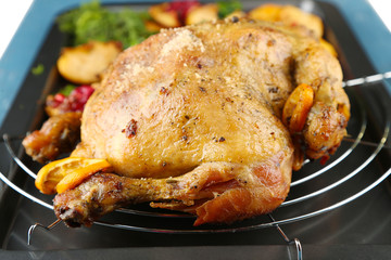 Whole roasted chicken with vegetables and fried potatoes