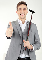 Naklejka premium Elegant young businessman playing mini golf at home