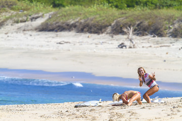 Fototapeta na wymiar Surfer girls on a beach