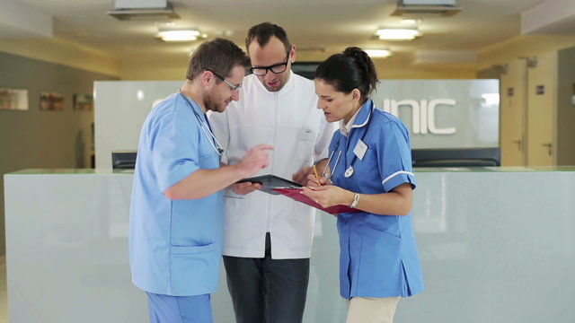 Group of medical workers consulting something in hospital