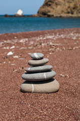 Fototapeta na wymiar close up shot of stone pile on beach over clear sky