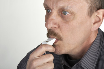 Close up of a referee blowing a whistle