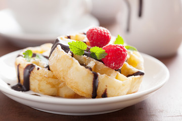 Belgian waffles with chocolate and raspberry for breakfast