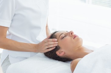 Fototapeta na wymiar Woman receiving head massage from therapist
