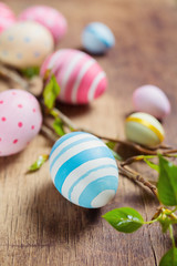 Fototapeta na wymiar Colorful Easter eggs and branch tree with spring buds