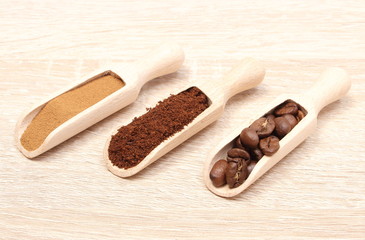 Grains, ground and instant coffee on wooden spoon