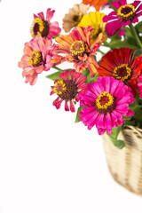 Bouquet from different brights in a basket on a white background