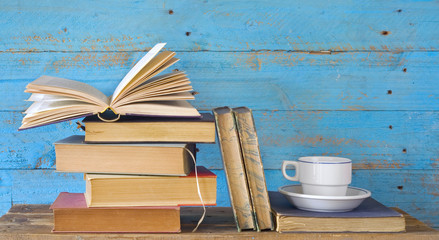 row of vintage books, with coffee cup, free copy space © Thomas Bethge