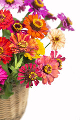 Bouquet from different brights in a basket on a white background
