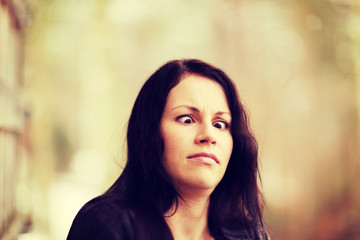 Obraz premium Young woman showing funny squint