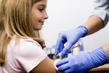 Vaccine - a doctor giving  vaccination girl, prevention - obrazy, fototapety, plakaty
