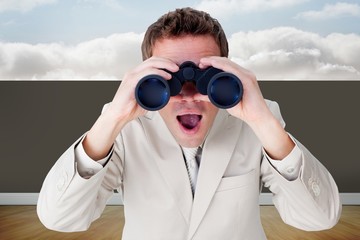 Composite image of positive businessman using binoculars