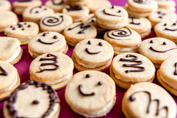 Crunchy mixed happy cookies on a purple plate