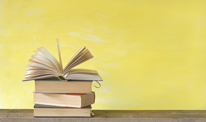 Open book on yellow background, free copy space