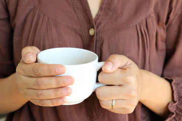 Hot coffee cup in woman hand.
