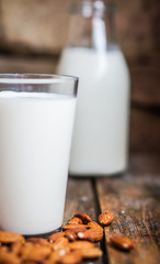 Almond milk on rustic wooden table