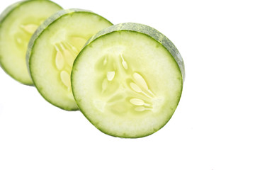 Stack of green cucumber slices with reflection isolated on white