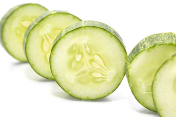 Stack of green cucumber slices with reflection isolated on white