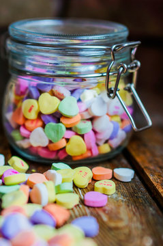 Heart candies on rustic wooden background