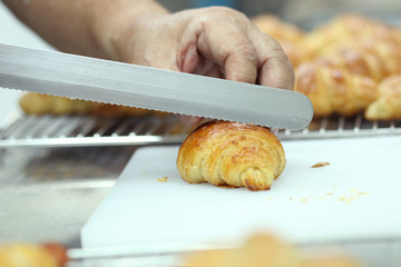 Hand cutting croissant