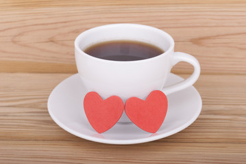 Cup of coffee and two hearts.