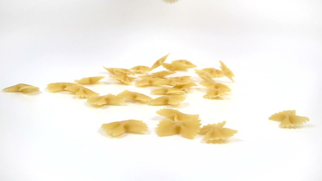 farfalle pasta falling on white background in slow motion