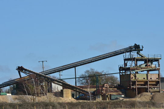 Large gravel extraction equipment with blue sky background