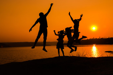 silhouette family jumping