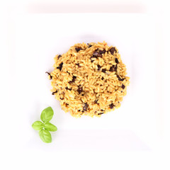 Risotto with mushrooms on a plate decorated with basil