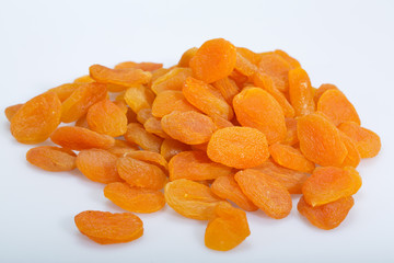 A heap of dried apricots on a white background