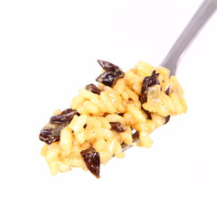 Risotto with mushrooms on a plate decorated with basil