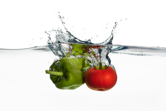 Fresh Tomato and Pepper Splash in Water Isolated on White Backgr