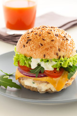 Burger with meat and vegetables.