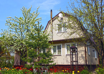 Garden house surrounded by blossoming trees