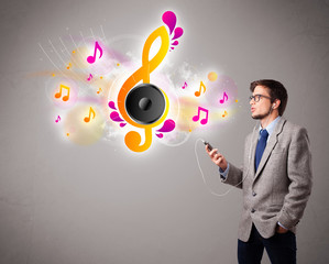 young man singing and listening to music with musical notes