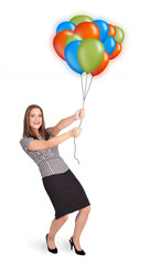 Young woman holding colorful balloons