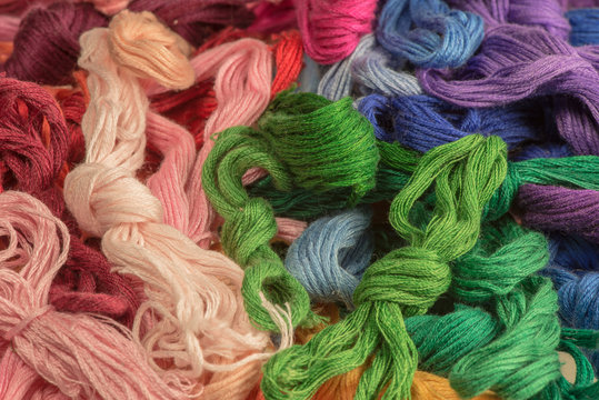 skeins of colored threads for embroidery - muline. background