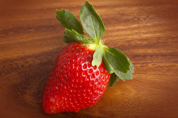 A ripe red strawberries on wooden table