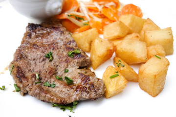 beef meat with tomato and french fries
