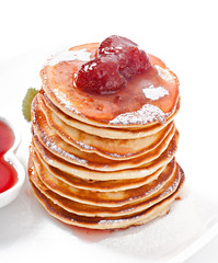 Delicious pancakes with strawberry jam