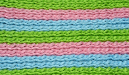 Texture of knitting wool in green, blue and pink color