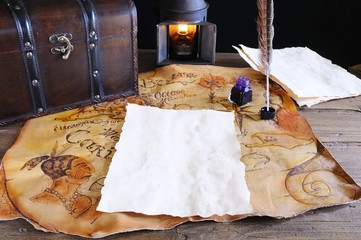 Work desk with parchment and old map.